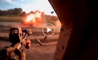 Fighters shoot from machine guns at a Russian drone-waiter sitting in ambush on the road, and destroy it