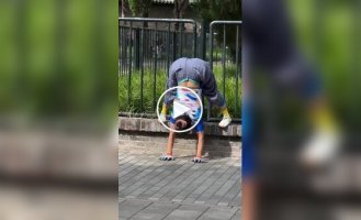 An elderly Chinese woman stretches in the park