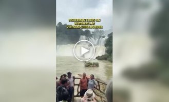 A man caught fish in a waterfall