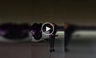An overturned Tesla and a dance in the middle of the road