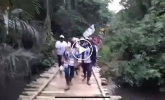 A wooden bridge collapses during a grand opening in Congo