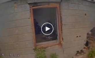 A drone flies through a window into a room where four occupiers are sitting