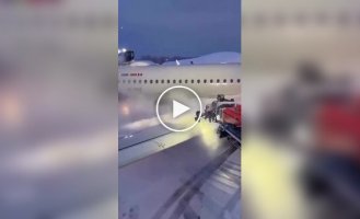 Plane being cleared of snow before takeoff