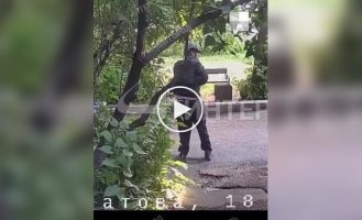A Russian who survived in Ukraine, wearing a helmet, a bulletproof vest and holding a machine gun, is conducting his operation near his home in Chelyabinsk