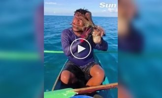An octopus latched onto a fisherman's face