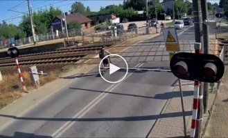 A guy drove through a closed crossing and miraculously avoided a collision