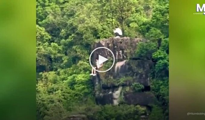 Tourists camped on the very edge of a cliff