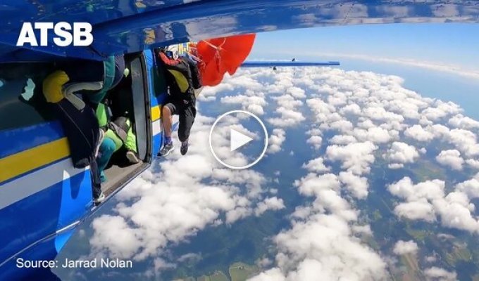 A man's parachute got caught on the tail of an airplane