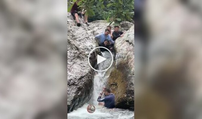 Men rescue boy stuck between huge boulders in turbulent river