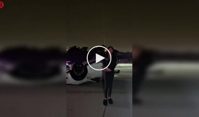 An overturned Tesla and a dance in the middle of the road