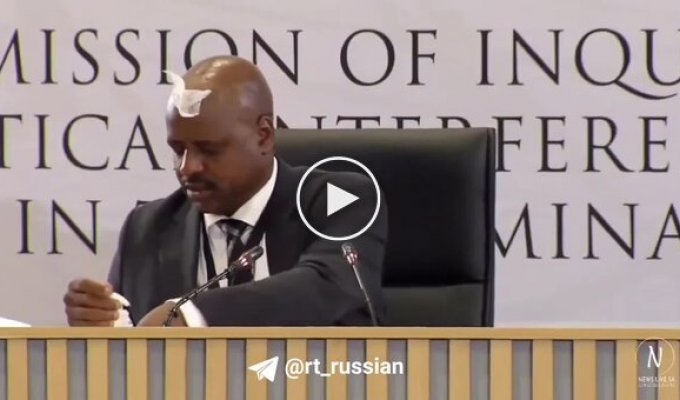 A napkin stuck to the forehead of a former South African official during a corruption hearing.