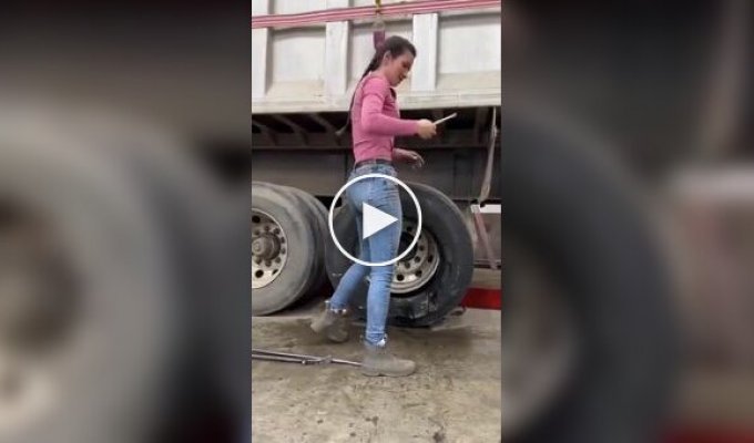 A girl changed a truck tire herself.