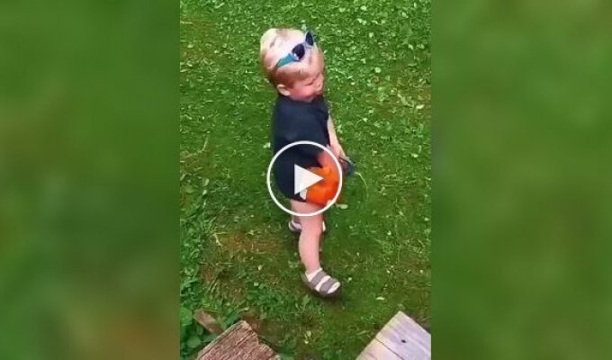 The perfect job: a toddler imitates mowing the lawn on a broken lawn mower