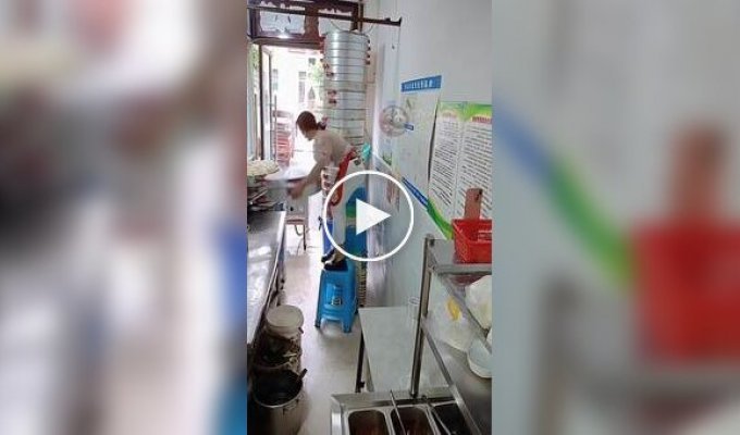 A diner owner lifts 24 tiers of steamed buns at a time.