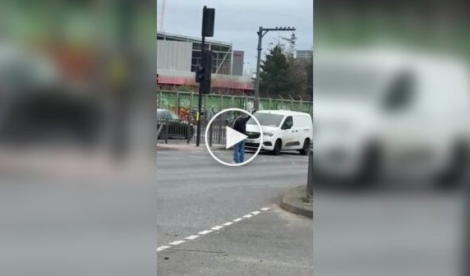 In London, a passerby helped direct traffic after a traffic light failed