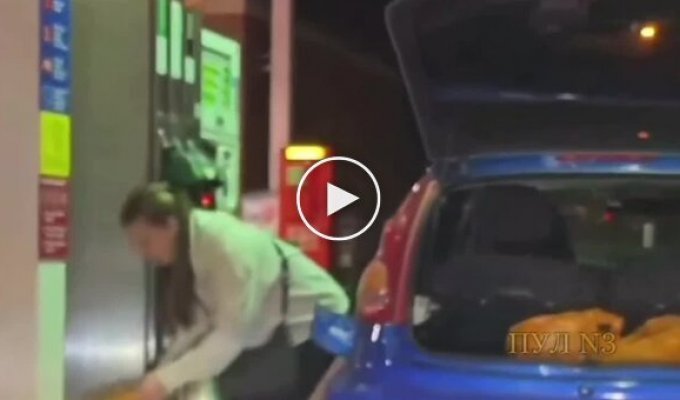 A girl was filling plastic bags with gas at a gas station