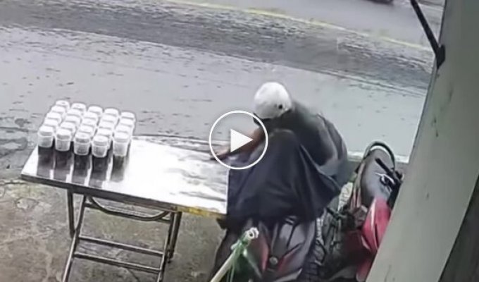A man tried to pull out a motorcycle and accidentally knocked over a table with tea